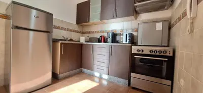 a kitchen with a stainless steel refrigerator and cabinets at Escale Marrakech in Marrakech