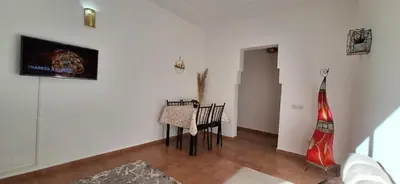 a dining room with a table and chairs in a room at Escale Marrakech in Marrakech