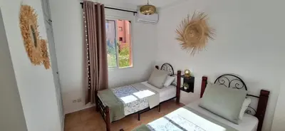 a living room with a bench and a window at Escale Marrakech in Marrakech