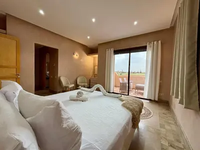 a bedroom with a large bed and a large window at Private Villa BSF - Pool & Spa - Palm Golf in Marrakech