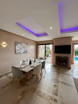 a dining room with a table and chairs and a fireplace at Private Villa BSF - Pool & Spa - Palm Golf in Marrakech