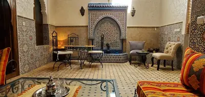 a living room with a table and chairs at Riad Dar Si Driss in Marrakech