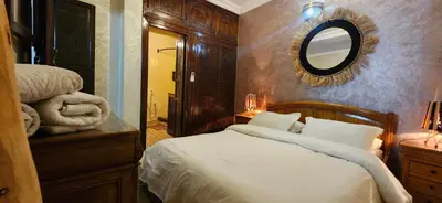 a bedroom with a bed with a mirror on the wall at Riad Dar Si Driss in Marrakech