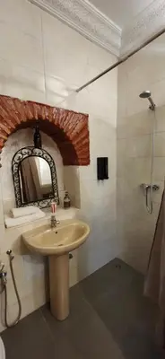 a bathroom with a sink and a mirror at Riad Dar Si Driss in Marrakech