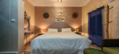 a bedroom with a large white bed in a room at Riad Dar Si Driss in Marrakech