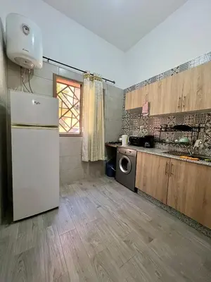 a kitchen with a white refrigerator and a sink at MyZo Superbe Appartement familial bien situé à Marrakech in Marrakech