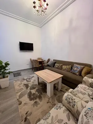 a living room with a couch and a table at MyZo Superbe Appartement familial bien situé à Marrakech in Marrakech