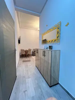a hallway with a room with a table and a door at MyZo Superbe Appartement familial bien situé à Marrakech in Marrakech