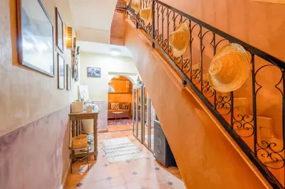 a staircase in a home with a wrought iron railing at Little Riad 3 Rooms - Top emplacement 5 minuts from Place Jemaa el fna & souk in Marrakech