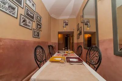a dining room with a long table and chairs at Little Riad 3 Rooms - Top emplacement 5 minuts from Place Jemaa el fna & souk in Marrakech