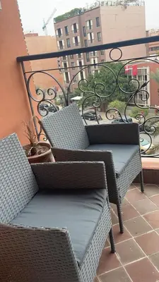 two wicker chairs sitting on top of a balcony at Résidence Elsalam Marrakech in Marrakech