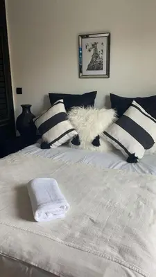 a white bed with pillows and towels on it at Résidence Elsalam Marrakech in Marrakech