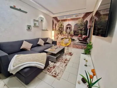 a living room with a blue couch and a table at Marrakeschzentrum Hideaway in Marrakech