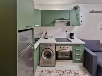 a kitchen with green cabinets and a washing machine at Marrakeschzentrum Hideaway in Marrakech