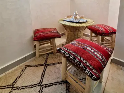 a small table and two stools in a room at Marrakeschzentrum Hideaway in Marrakech