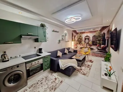 a kitchen and living room with a purple couch at Marrakeschzentrum Hideaway in Marrakech