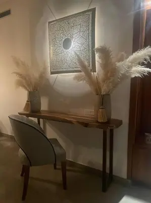 a wooden desk with a chair and a light on it at Villa Bohème avec personnel de maison in Marrakech