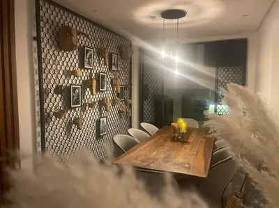 a dining room with a wooden table and chairs at Villa Bohème avec personnel de maison in Marrakech