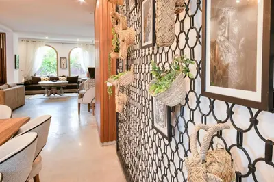 a living room with a wall with plants on it at Villa Bohème avec personnel de maison in Marrakech