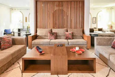 a living room with a couch and a coffee table at Villa Bohème avec personnel de maison in Marrakech
