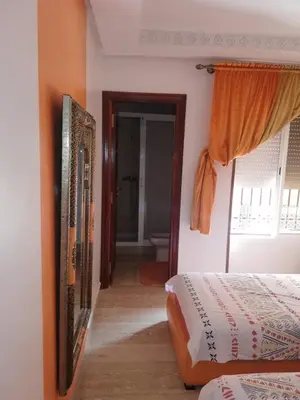 a bedroom with a bed and a mirror on the wall at RESIDENCE HAMZA Cosy appartement only family à Gueliz in Marrakech