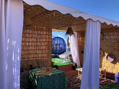 a room with a table and a globe in the background at Riad Ramona lQariya seyaheya in Marrakech