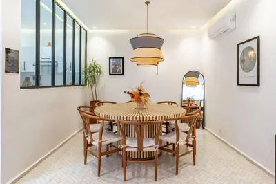 a dining room with a table and chairs at RIAD LE M neuf et contemporain in Marrakech