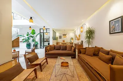 a living room with couches and a table at RIAD LE M neuf et contemporain in Marrakech