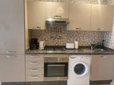 a kitchen with a washing machine and a washer at Bel appart wifi balcon et parking Marrakech centre in Marrakech