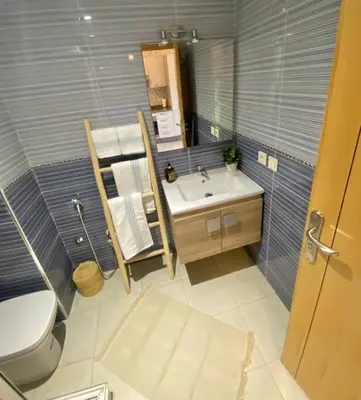a bathroom with a toilet and a sink and a mirror at Bel appart wifi balcon et parking Marrakech centre in Marrakech