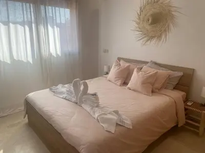 a bedroom with a large bed with towels on it at Bel appart wifi balcon et parking Marrakech centre in Marrakech