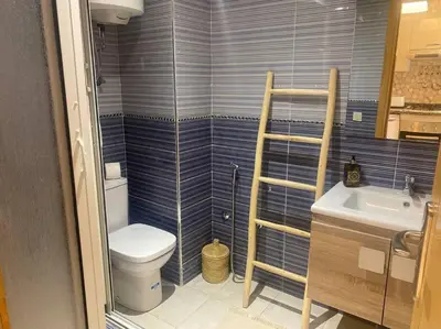 a small bathroom with a toilet and a sink at Bel appart wifi balcon et parking Marrakech centre in Marrakech