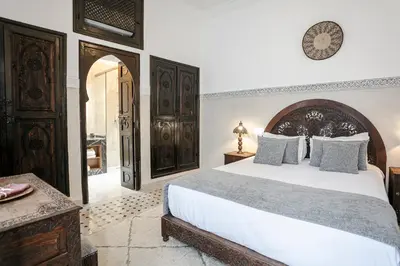 a bedroom with a large white bed in a room at RIAD ELNOUJOUM in Marrakech