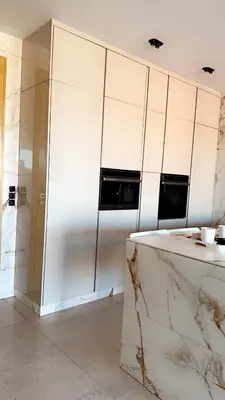 a bathroom with white cabinets and a marble counter at Superbe appartement de luxe a l'hivernage marrakech in Marrakech