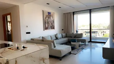 a living room with a couch and a table at Superbe appartement de luxe a l'hivernage marrakech in Marrakech