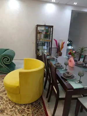 a dining room with a table and a yellow chair at Private Villa with private Chef optional in Marrakech