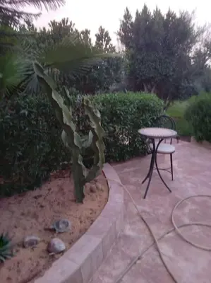 a patio with a table and a table and a chair at Private Villa with private Chef optional in Marrakech