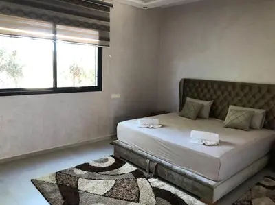 a bedroom with a bed with two towels on it at Private Villa with private Chef optional in Marrakech