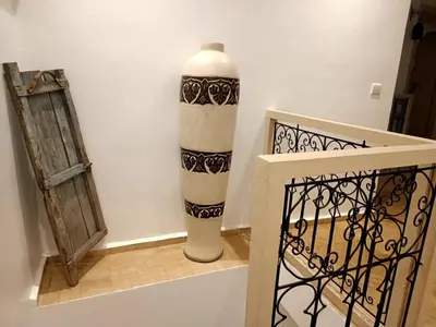 a black and white vase sitting next to a door at Riad KaBaYa Charme Exclusif Privatisé 2 à 8 Pers. in Marrakech