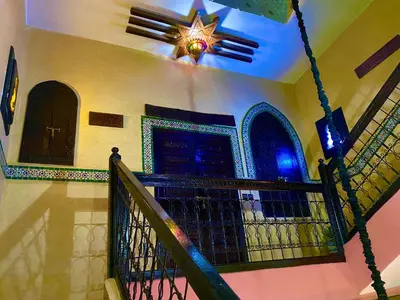 a house with a staircase with a door and a ceiling at Riad Atlas avec jacuzzi 3 piscines au cœur de Marrakech in Marrakech