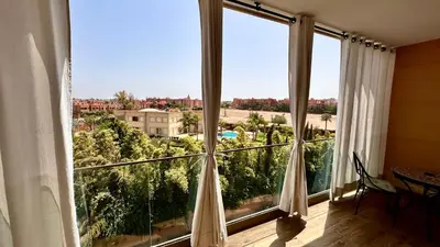 a room with a large window with a view at Pearl Garden Studio Cozy Panoramic Charming sunny Terrace Piscine in Marrakech