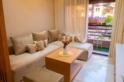 a living room with a couch and a table at Appartement Marrakech Hivernage N2 RESIDENCE CAPRICE PALACE in Marrakech
