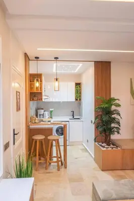 a kitchen with a counter and stools in a room at Appartement Marrakech Hivernage N2 RESIDENCE CAPRICE PALACE in Marrakech