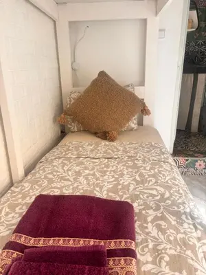 a bed with a pillow on top of it at Riad Sanwa in Marrakech