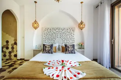 a bedroom with a bed with two pillows on it at Villa Serenity & SPA - Breakfast in Marrakech