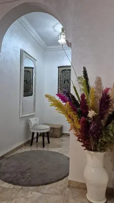 a living room with a vase with flowers in it at Lala's apartment in Marrakech