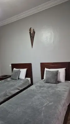 two beds sitting next to each other in a bedroom at Lala's apartment in Marrakech