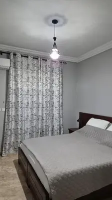 a bedroom with a bed and a large window at Lala's apartment in Marrakech