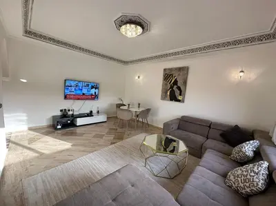 a living room with a couch and a table at Luxury, Cosy Apartement (Wifi, Balcony, Parking) in Marrakech