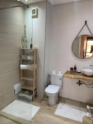 a bathroom with a toilet and a sink and a mirror at Luxury, Cosy Apartement (Wifi, Balcony, Parking) in Marrakech